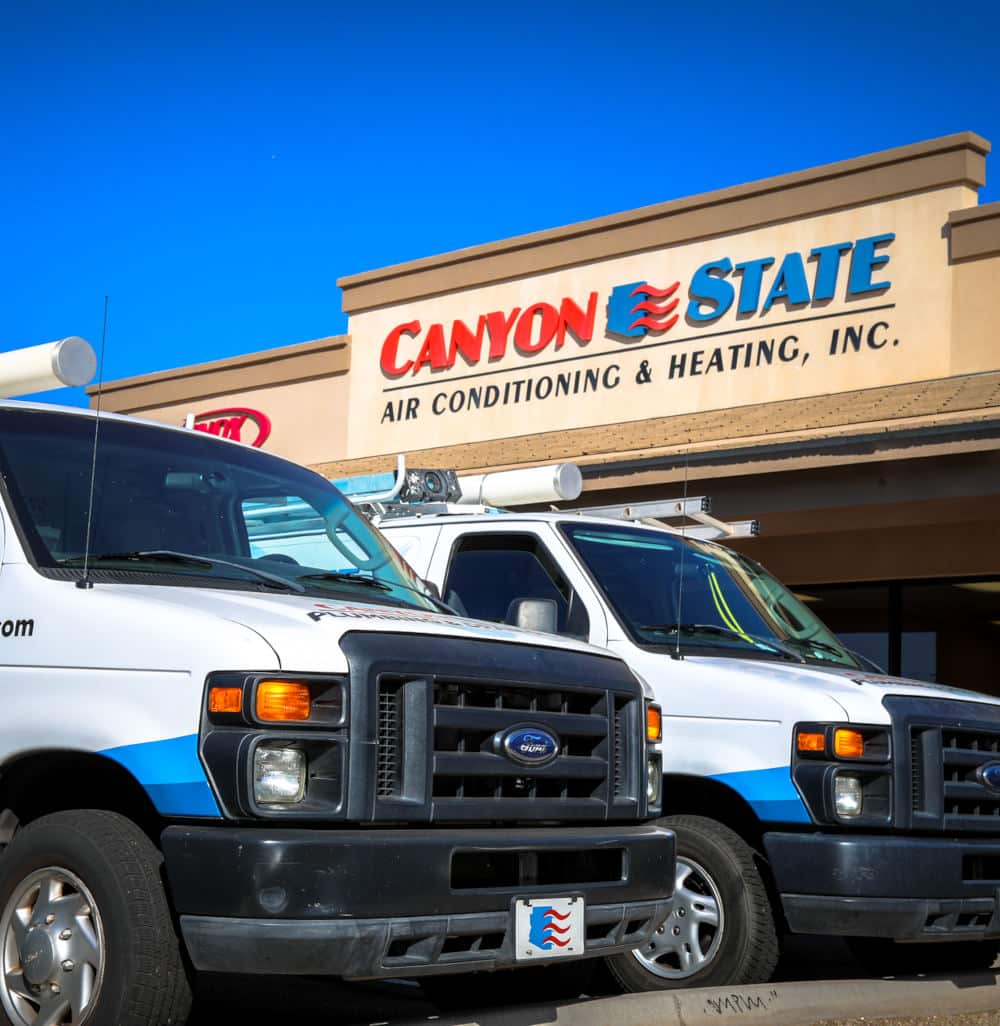 canyon state building with a plumbing van parked in front